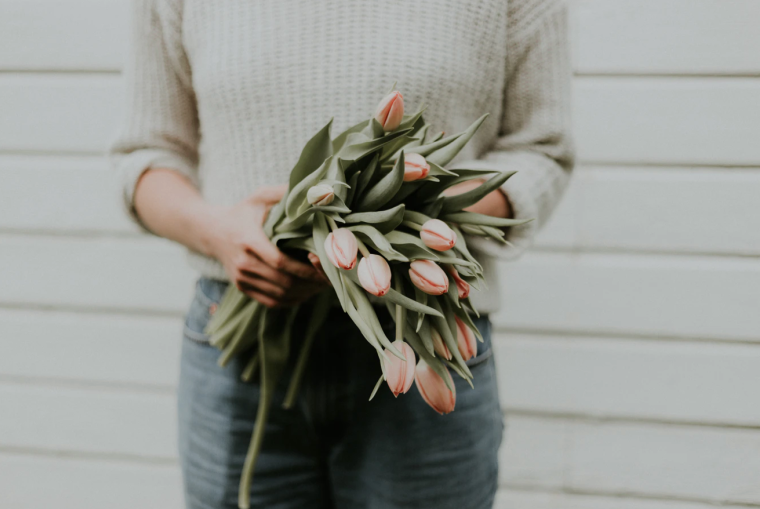 a lady with a flower. using flower to appreciate a childless woman